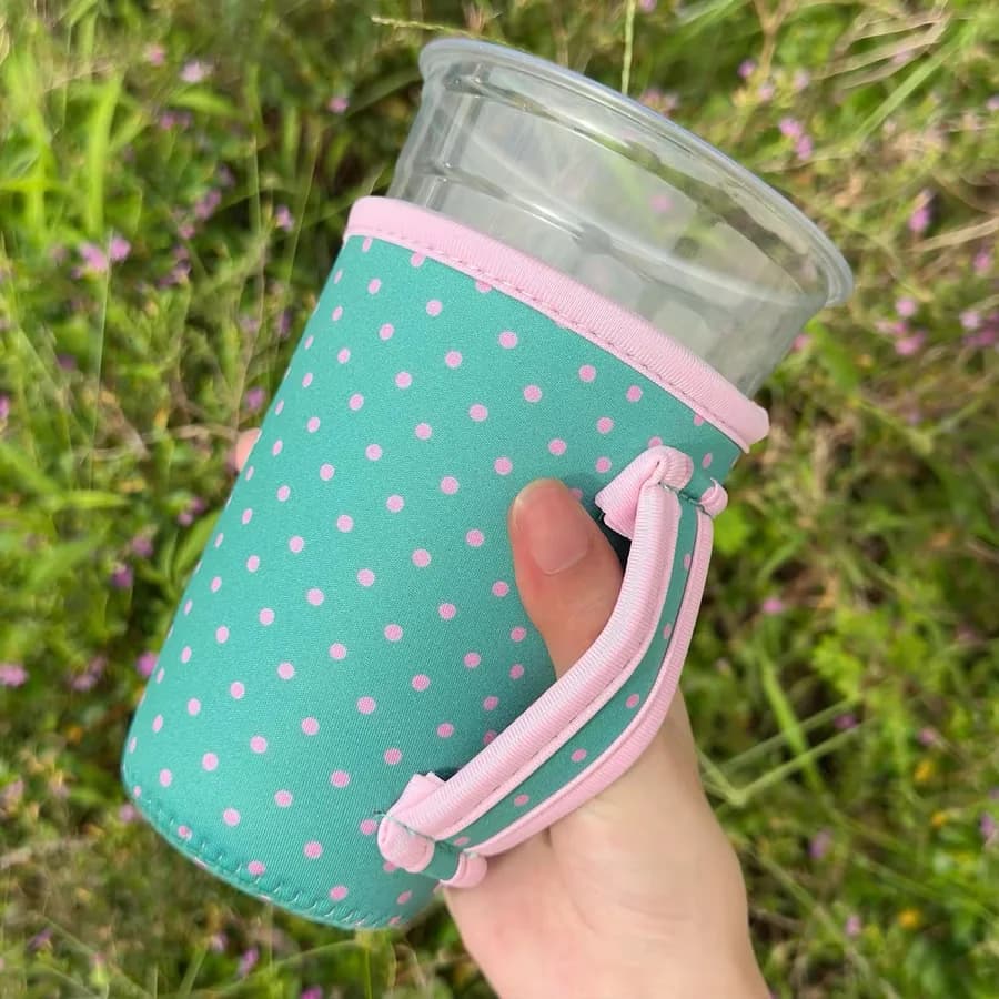 Polka dot neoprene coffee sleeve with a bound handle